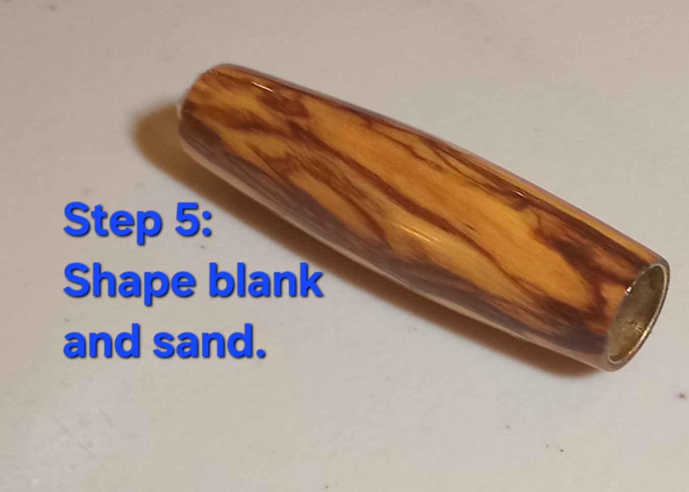Shape & sand — olivewood barrel turned to its final rounded profile