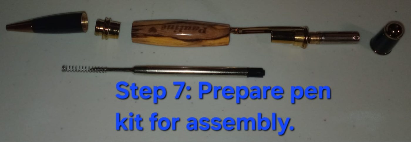 Prepare the kit — pen components laid out in order: cap, nibs, clip, barrel, refill and spring
