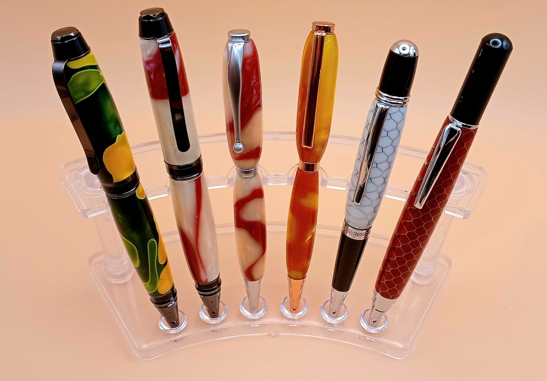 Vibrant swirled resin pens in green-yellow, red-white, orange, honeycomb and snakeskin patterns